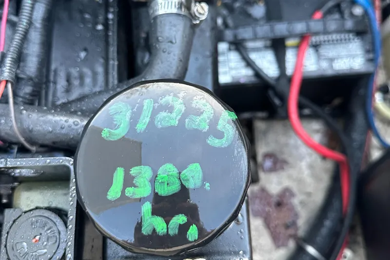 Slide: The Image of Engine compartment of 2006 Rinker 262 Captiva Bowrider showing 31225, 1300 hours. - 25