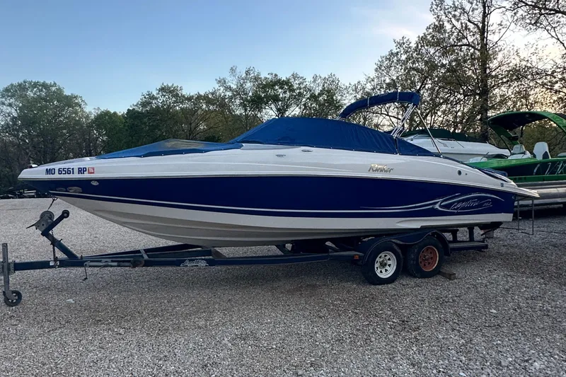 Slide: The Image of 2006 Rinker 262 Captiva Bowrider on trailer, parked outdoors. - 3