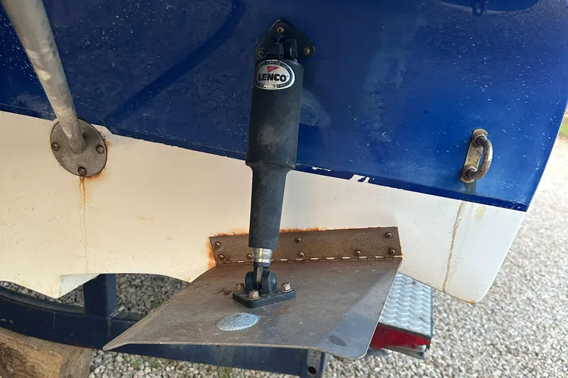 Slide: The Image of Trim tab on a 2006 Rinker 262 Captiva Bowrider boat. - 30