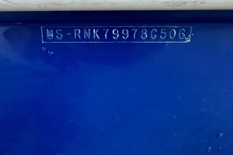 Slide: The Image of Hull identification number on 2006 Rinker 262 Captiva Bowrider, blue background. - 31