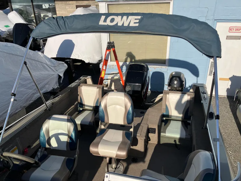 Slide: The Image of 2006 Lowe Fish & Ski FS175 boat interior with seating and canopy. - 3