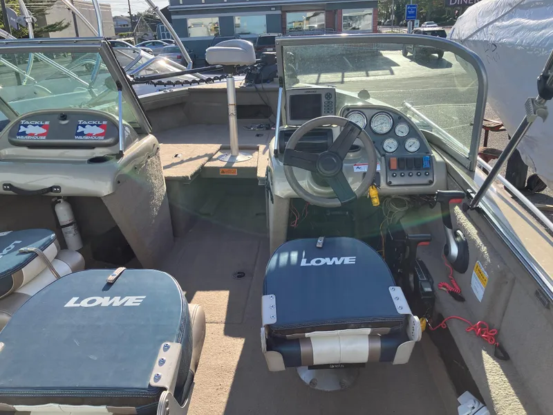 Slide: The Image of 2006 Lowe Fish & Ski FS175 boat interior with steering wheel and seating. - 5