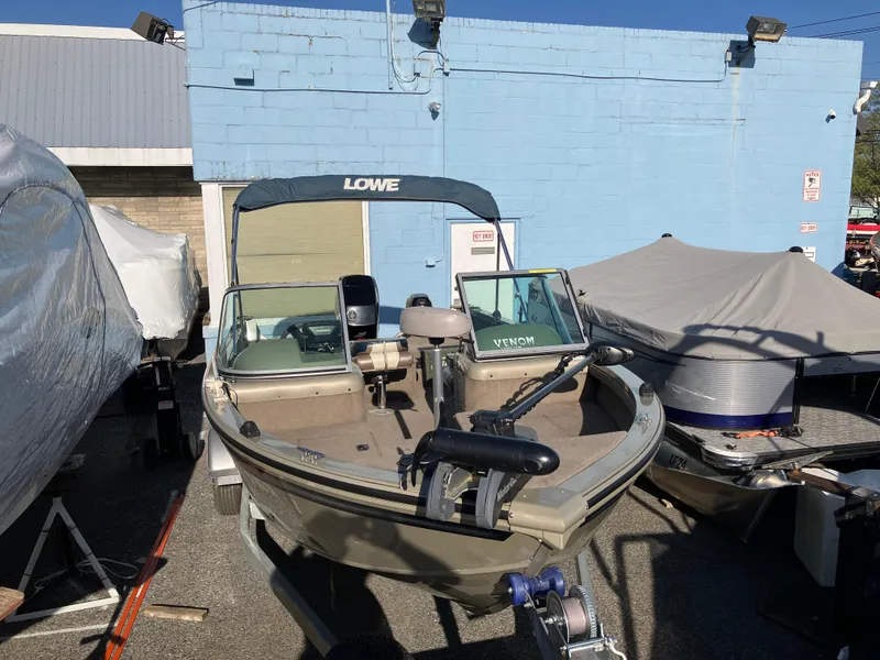 Slide: The Image of 2006 Lowe Fish & Ski FS175 boat parked outdoors near a blue building. - 7