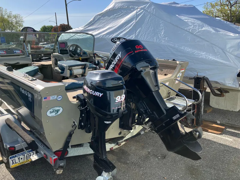 Slide: The Image of 2006 Lowe Fish & Ski FS175 boat with dual Mercury outboard motors on a trailer. - 8