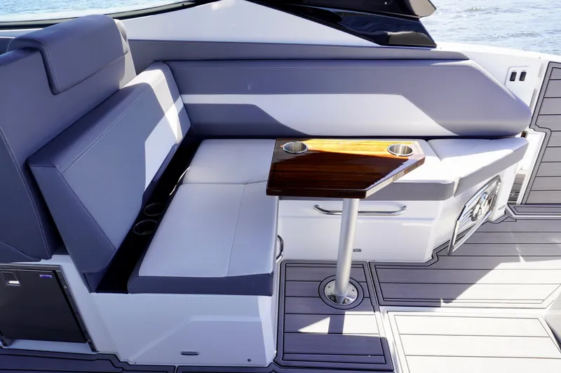 Slide: The Image of Luxurious seating area on 2020 Cruisers Yachts 38 GLS OB with sleek table design. - 12