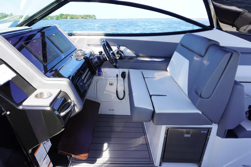 Slide: The Image of 2020 Cruisers Yachts 38 GLS OB interior with modern helm and seating, overlooking the water. - 13