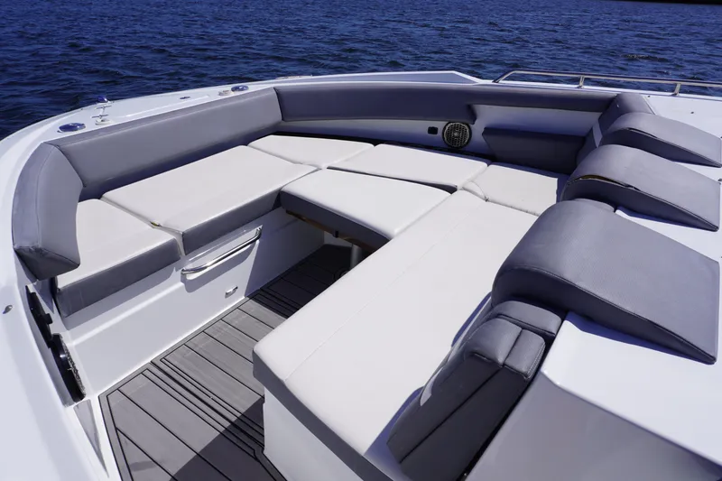 Slide: The Image of Luxurious seating area on 2020 Cruisers Yachts 38 GLS OB, overlooking serene blue waters. - 16