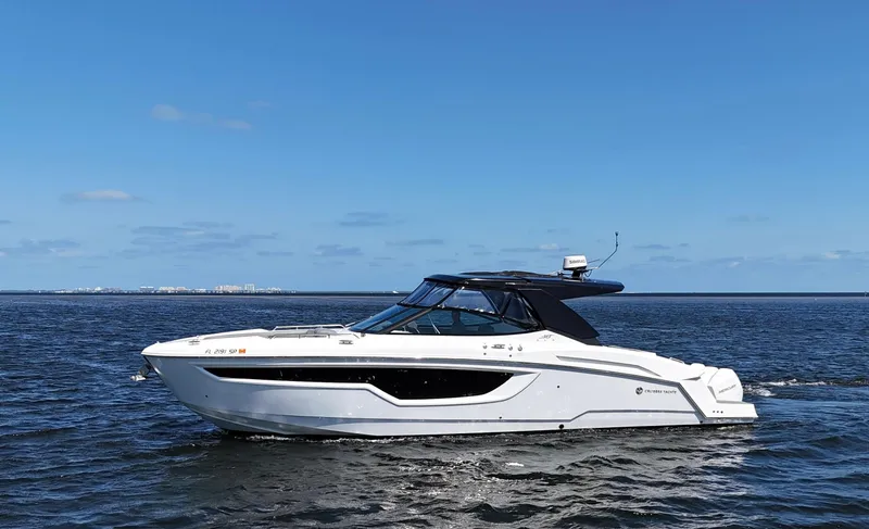 Slide: The Image of 2020 Cruisers Yachts 38 GLS OB on open water under clear blue sky. - 2