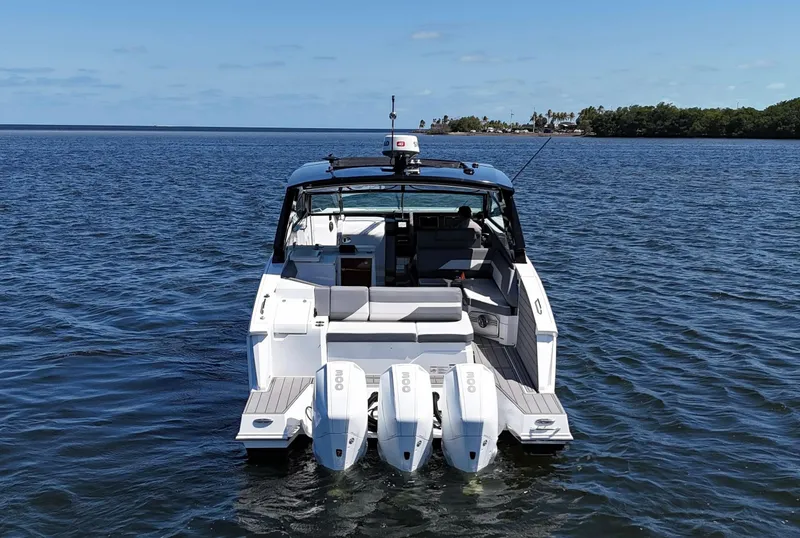 Slide: The Image of 2020 Cruisers Yachts 38 GLS OB on water, rear view with triple outboard engines. - 3