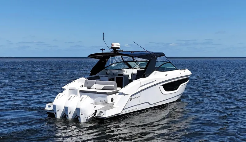 Slide: The Image of 2020 Cruisers Yachts 38 GLS OB on open water, featuring triple outboard engines. - 4