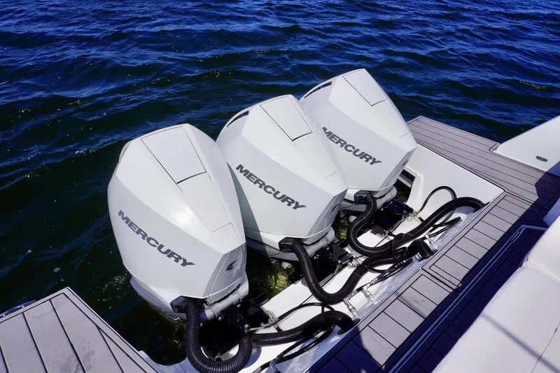 Slide: The Image of Triple Mercury outboard engines on a 2020 Cruisers Yachts 38 GLS OB, docked on water. - 5