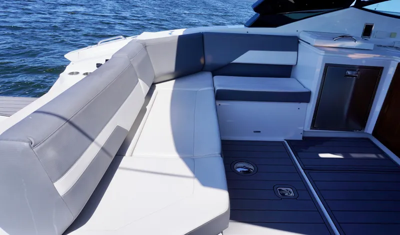 Slide: The Image of 2020 Cruisers Yachts 38 GLS OB interior with sleek seating and modern design on open water. - 8