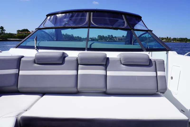 Slide: The Image of 2020 Cruisers Yachts 38 GLS OB boat with gray seating and clear windshield on a sunny day. - 18