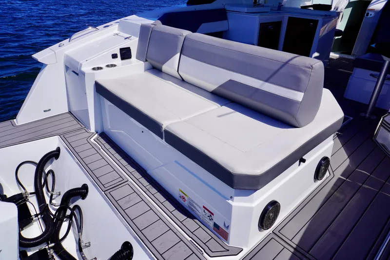 Slide: The Image of 2020 Cruisers Yachts 38 GLS OB boat seating area with gray cushions and deck view. - 6