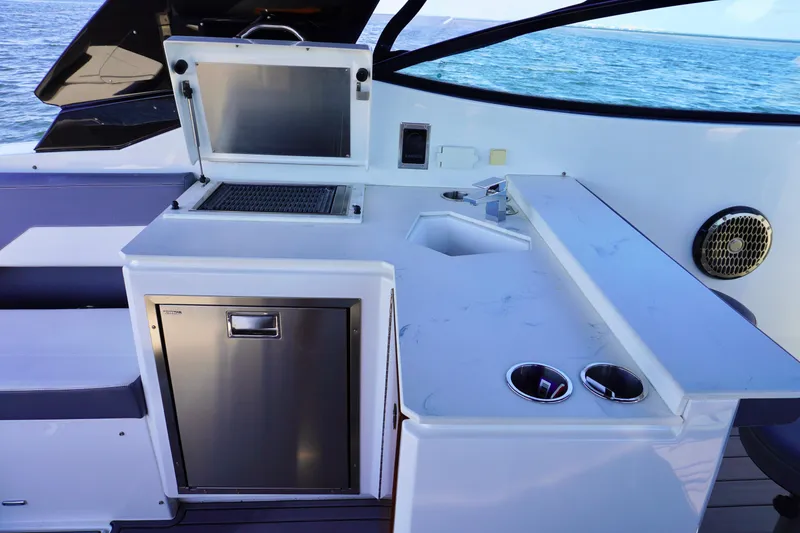 Slide: The Image of Outdoor kitchen on 2020 Cruisers Yachts 38 GLS OB, featuring grill and sink. - 9