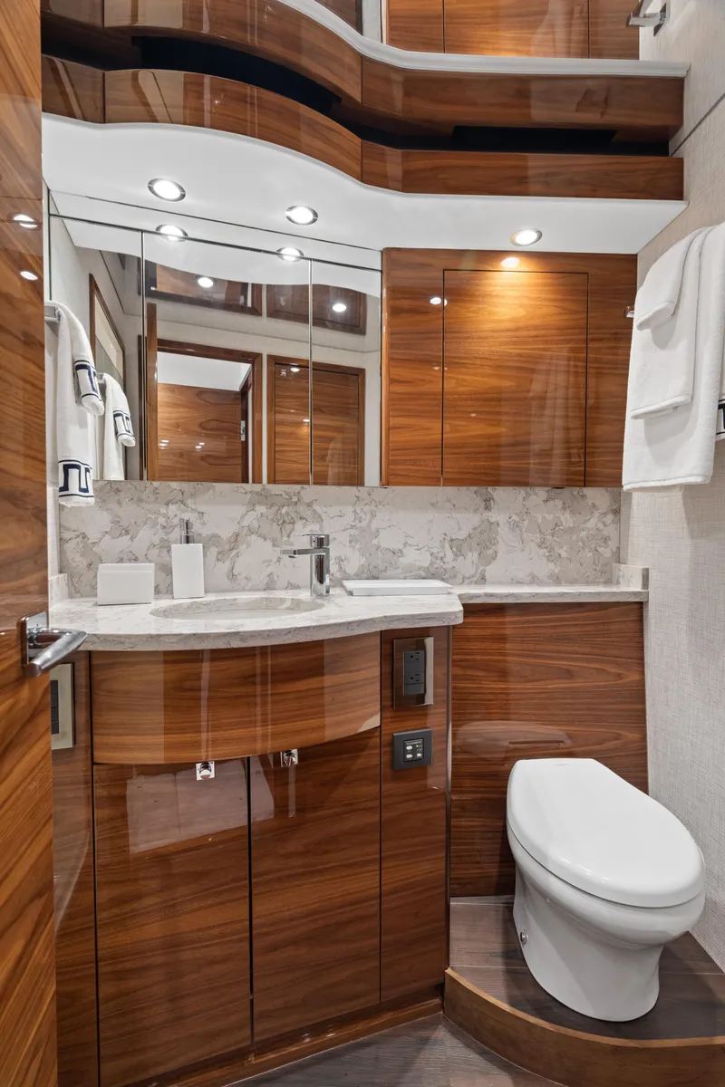 Slide: The Image of Luxurious bathroom in 2025 Viking 58 Convertible yacht with modern wood cabinetry and elegant fixtures. - 12