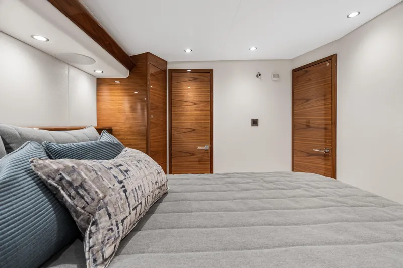 Slide: The Image of Luxurious bedroom interior of 2025 Viking 58 Convertible yacht with modern wood accents. - 13