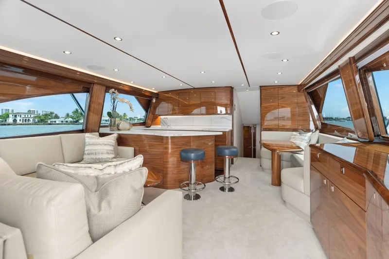 Slide: The Image of Luxurious interior of 2025 Viking 58 Convertible yacht with elegant wood finishes and plush seating. - 15