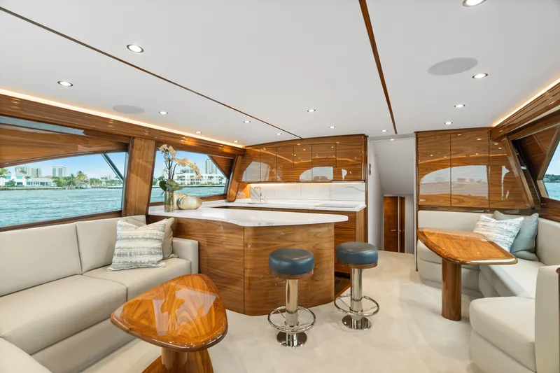 Slide: The Image of Luxurious interior of 2025 Viking 58 Convertible yacht with elegant wood finishes and modern seating. - 25