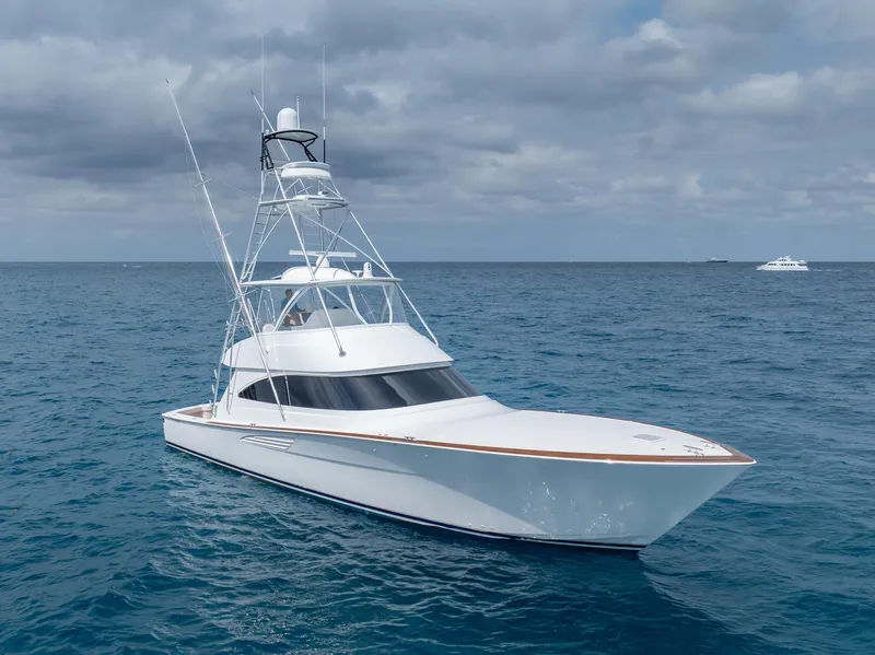 Slide: The Image of 2025 Viking 58 Convertible yacht cruising on open sea under cloudy sky. - 3