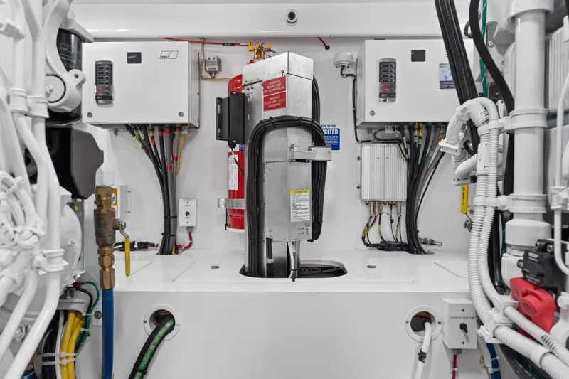 Slide: The Image of Engine room of 2025 Viking 58 Convertible yacht, featuring electrical panels and fire suppression system. - 37