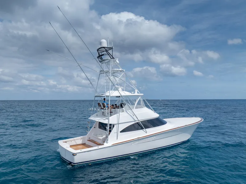 Slide: The Image of 2025 Viking 58 Convertible yacht cruising on open ocean under cloudy sky. - 4