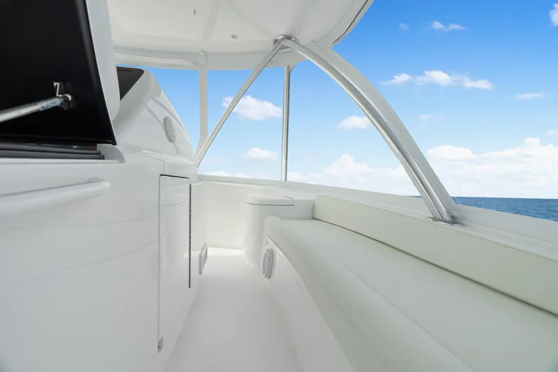 Slide: The Image of 2025 Viking 58 Convertible yacht interior with sleek white seating and ocean view. - 48