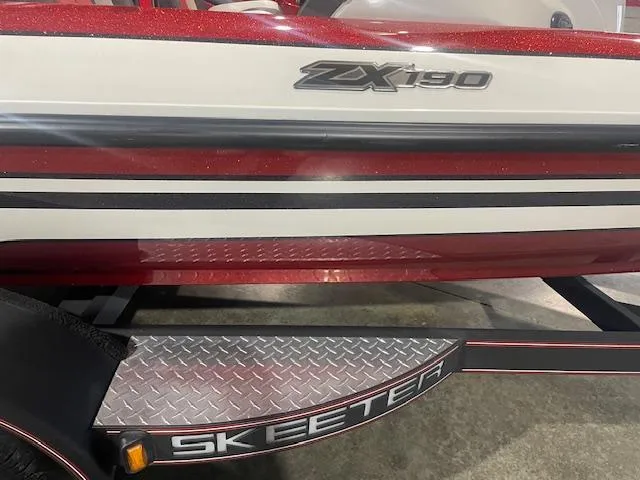 Slide: The Image of 2019 Skeeter ZX190 boat with red and white detailing on a trailer. - 3