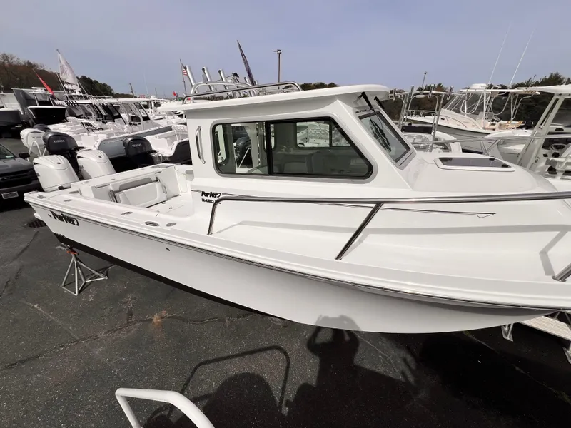 Slide: The Image of 2025 Parker 2420 boat displayed at a marina, featuring a sleek white design. - 10