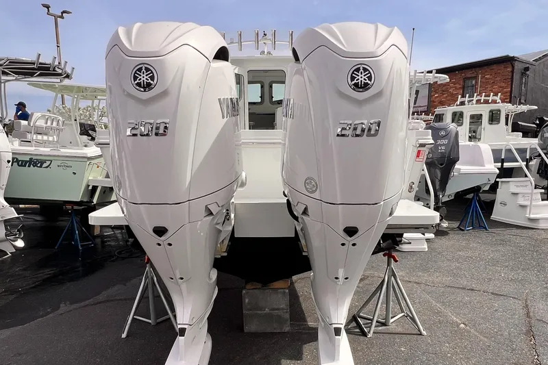 Slide: The Image of Twin Yamaha 200 outboard engines on a Parker 2420 boat, 2025 model, in a marina setting. - 11