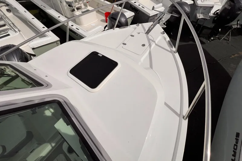 Slide: The Image of 2025 Parker 2420 boat deck with railing and hatch, showcasing sleek design. - 13