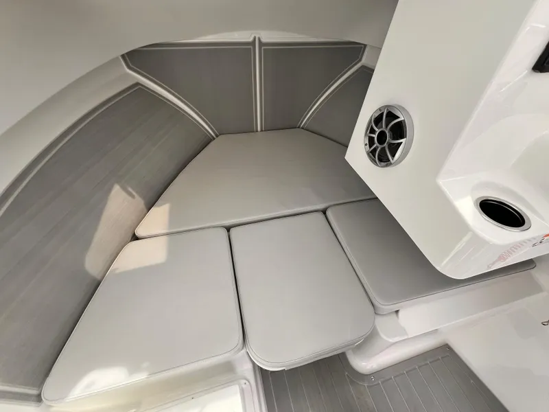 Slide: The Image of 2025 Parker 2420 boat interior with cushioned seating and speaker system. - 8