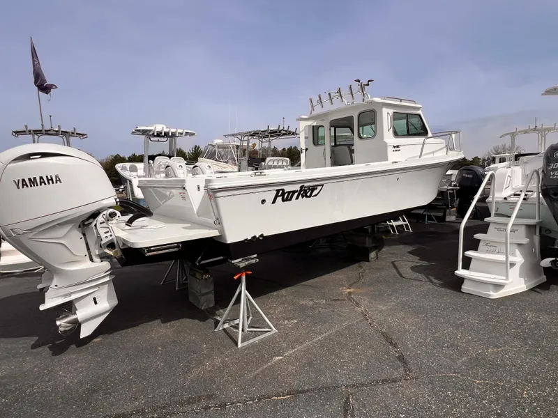 Slide: The Image of 2025 Parker 2420 boat with Yamaha engine displayed on a lot. - 9