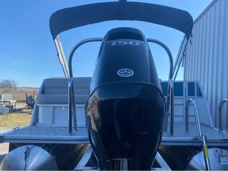 Slide: The Image of 2024 Trifecta 22CL2 LE pontoon boat with powerful 150 HP engine, docked outdoors. - 10