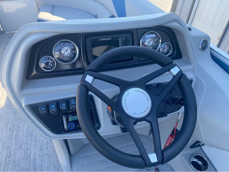 Slide: The Image of 2024 Trifecta 22CL2 LE boat dashboard with steering wheel and control panel. - 13