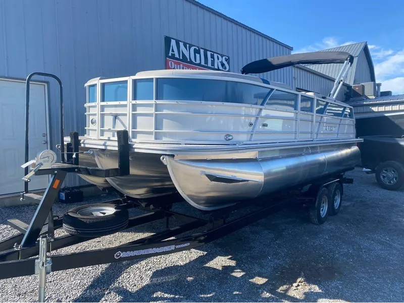 Slide: The Image of 2024 Trifecta 22CL2 LE pontoon boat on trailer, parked outdoors. - 15