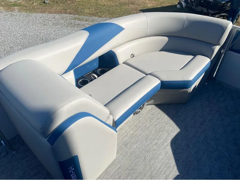 Slide: The Image of 2024 Trifecta 22CL2 LE boat interior with gray and blue seating, cup holders, and carpeted floor. - 2