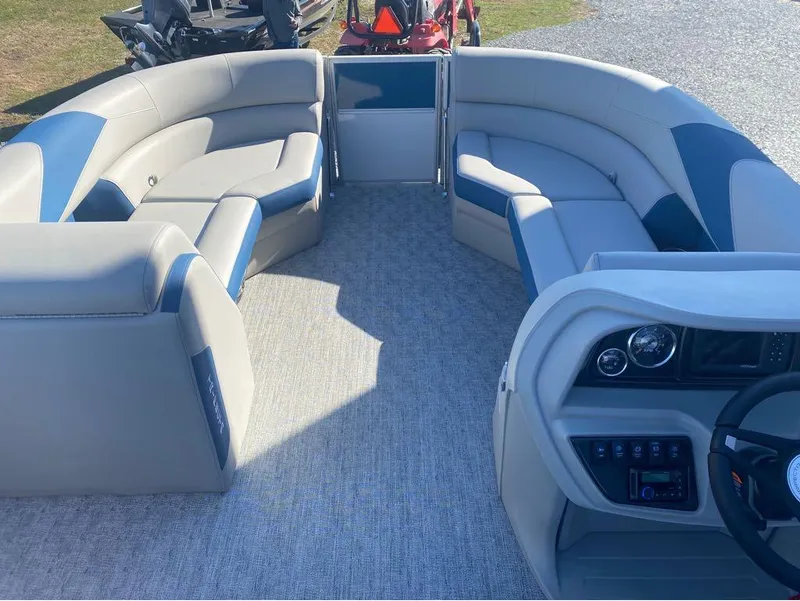 Slide: The Image of 2024 Trifecta 22CL2 LE pontoon boat interior with plush seating and modern dashboard. - 21