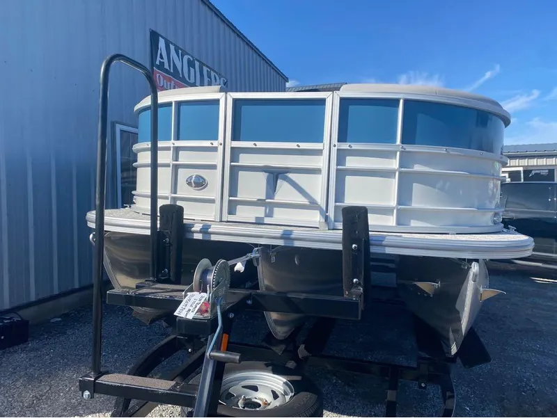 Slide: The Image of 2024 Trifecta 22CL2 LE pontoon boat on trailer, parked outside Anglers store. - 22