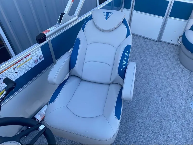 Slide: The Image of 2024 Trifecta 22CL2 LE boat seat with blue accents and logo. - 23