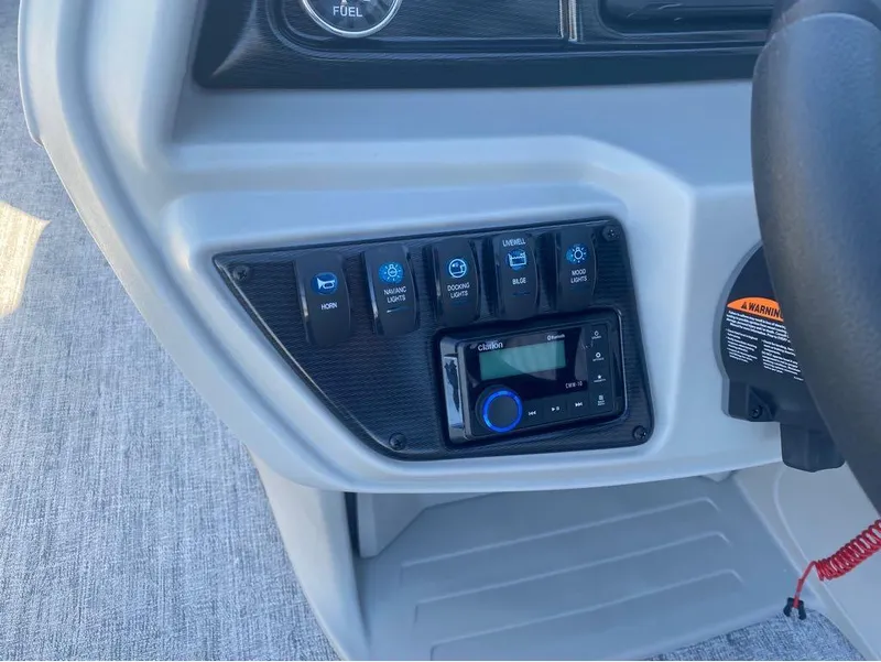 Slide: The Image of Control panel of 2024 Trifecta 22CL2 LE boat with switches and stereo system. - 30