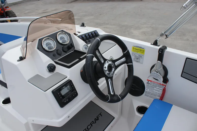 Slide: The Image of 2025 Starcraft SV 16 OB boat dashboard with steering wheel and control panel. - 10