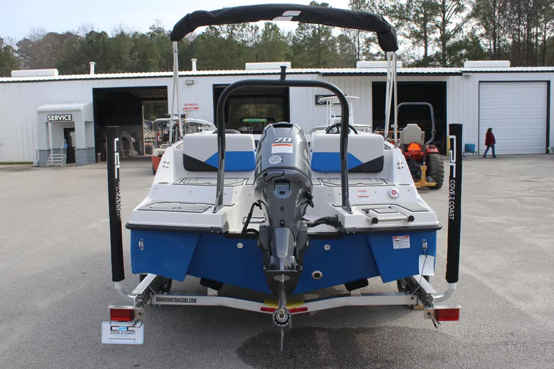 Slide: The Image of 2025 Starcraft SV 16 OB boat on trailer, rear view, parked at service facility. - 3