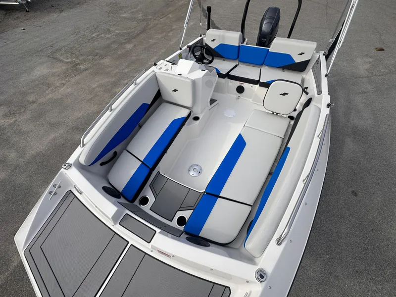 Slide: The Image of 2025 Starcraft SV 16 OB boat with blue and white seating, top view. - 5