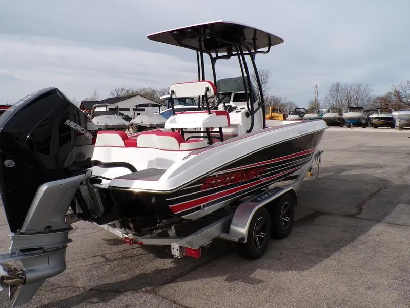 Slide: The Image of 2026 Statement 250 CC boat with Mercury engine on trailer, parked outdoors. - 14