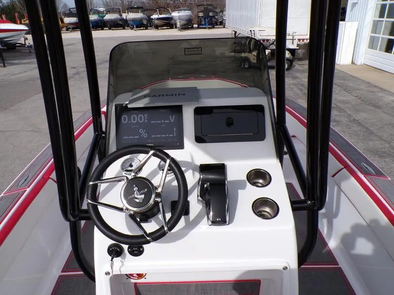 Slide: The Image of 2026 Statement 250 CC boat console with steering wheel and Garmin display. - 19