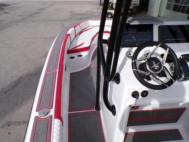 Slide: The Image of 2026 Statement 250 CC boat interior with red accents and modern steering console. - 4