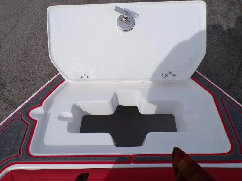 Slide: The Image of Open storage compartment on 2026 Statement 250 CC boat, featuring a secure latch. - 7