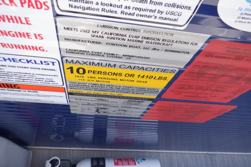 Slide: The Image of 2022 Bennington SX 22 Swingback capacity label, 10 persons or 1410 lbs, emission info. - 10