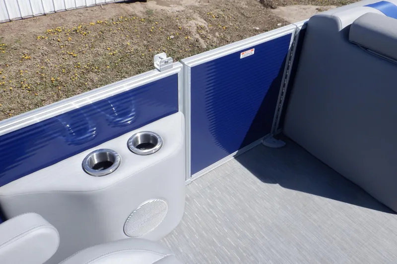 Slide: The Image of 2022 Bennington SX 22 Swingback interior with cup holders and blue paneling. - 15